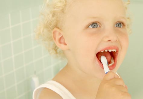 [Translate to czech:] kid cleaning teeth